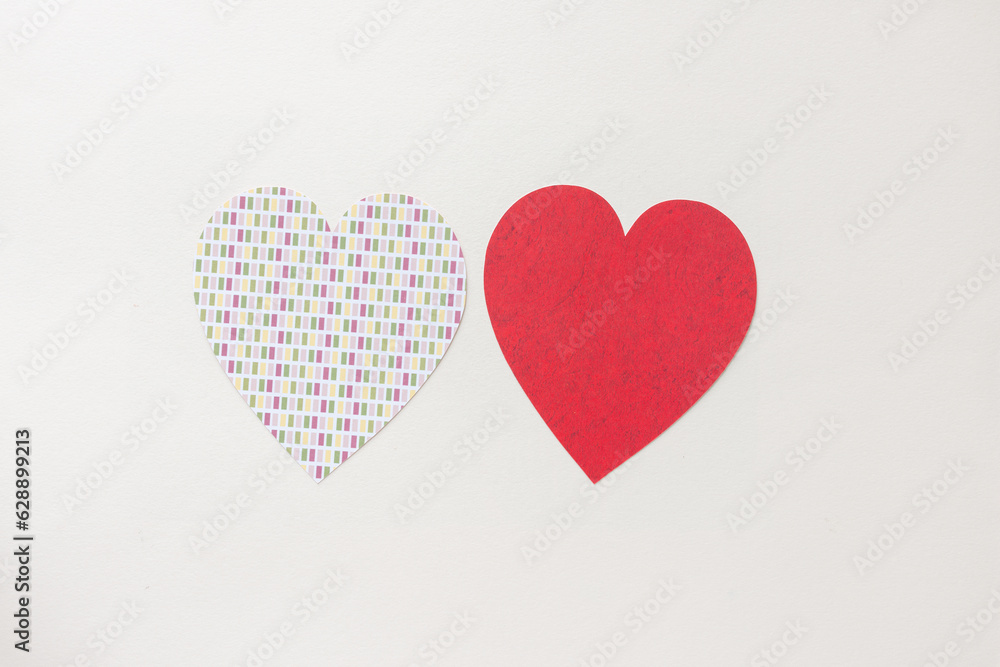 two hearts one with pattern the other red sharing and respecting the same graphical design space