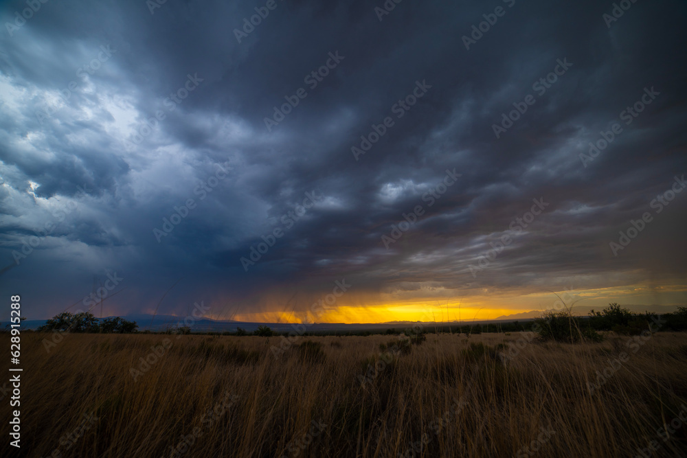 A dramatic monsoon thunderstorm over a desert highland