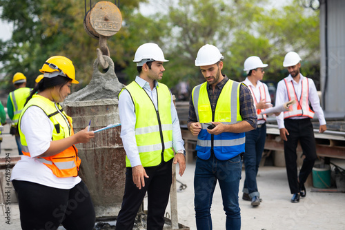 Diverse Team of construction Specialists. Obese female and hispanic male site engineers. professional engineering people in hardhat safety helmet meeting at Prefabricated concrete walls factory