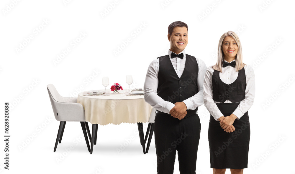 Obraz premium Male and female ervers in uniforms posing in front of a table