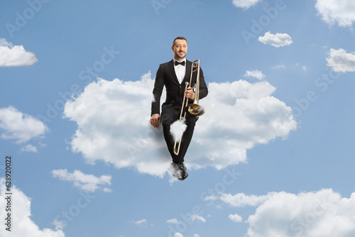 Wallpaper Mural Male musician in a black suit and bow-tie sitting on a cloud Torontodigital.ca