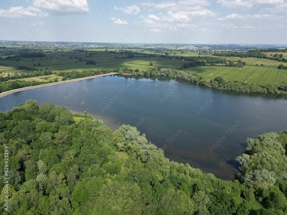 Scenic view of a tranquil lake situated in a forest, surrounded by trees and lush green vegetation