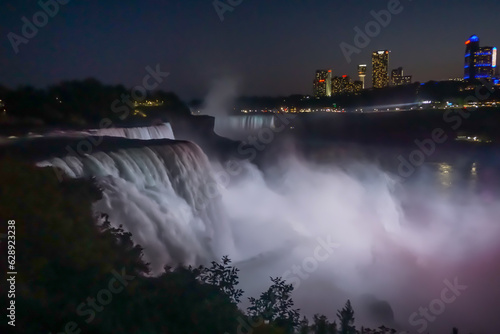 Niagara Falls, NY: The American Falls, the Horseshoe Falls (background), and hotels on the Canadian side of the gorge at night, from Prospect Point.