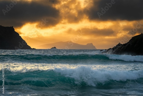 Stunning sunset is captured over a rocky shoreline as waves crash against the shore