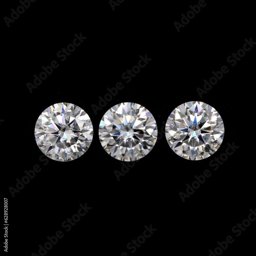 Closeup of diamonds under the lights isolated on a black background