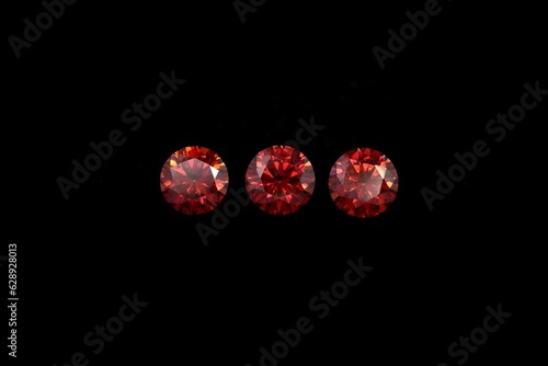 Closeup of beautiful rubies under the lights isolated on a black background