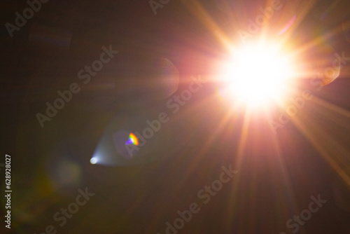 Slika na platnu Blurred image Sun flare on the black background