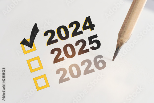 New year check list box with check mark in year 2024 on white paper with pencil.  Happiness with beginning selection concept and success solution idea photo