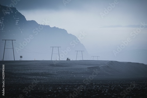 stunning landscape of electricity lines against snow-covered hills in Reykjavik, Iceland