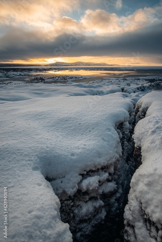 Breathtaking view of an icy snow-covered field in Reykjavik, Iceland during a stunning sunset