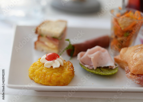 Square white plate with delicious, luxury finger food, amuses or bites, selective focus