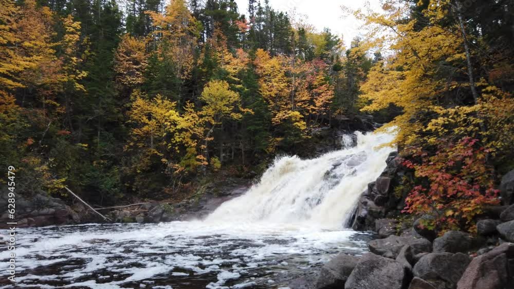 Mary Ann Waterfalls, Cape Breton, Nova Scotia. A vibrant high waterfall river in autumn season. Gushing water fall in an autumn forest landscape. Autumn waterfall view in Cape Breton. Mary Ann Waterfalls, Cape Breton, Nova Scotia. A vibrant high waterfall river in autumn season. Gushing water fall in an autumn forest landscape. Autumn waterfall view in Cape Breton.