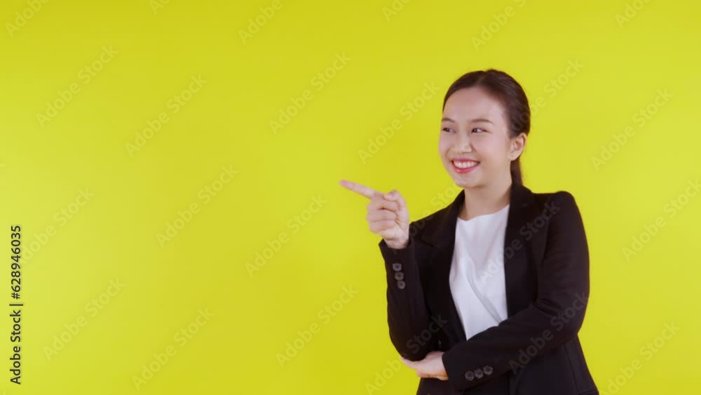 Portrait young asian business woman pointing and presenting isolated on yellow background, advertising and marketing, woman surprise and excited, businesswoman confident showing with expression. Portrait young asian business woman pointing and presenting isolated on yellow background, advertising and marketing, woman surprise and excited, businesswoman confident showing with expression.