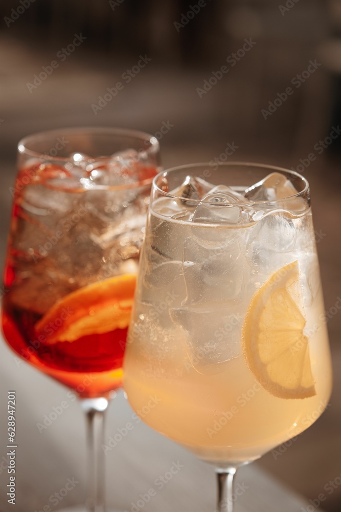 Closeup shot of crystal clear glasses filled with a refreshing alcoholic beverage and icecubes