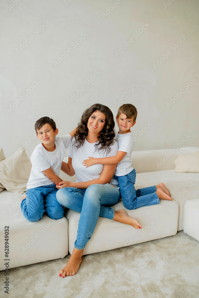 Mother sitting with sons on sofa Mother sitting with sons on sofa