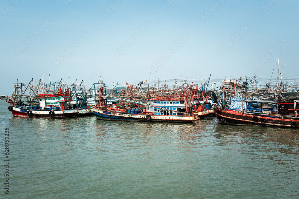 Fishing boat is out fishing. Fishermen is a career that has been popular in seaside city of Thailand. many fishing boats in the seaport