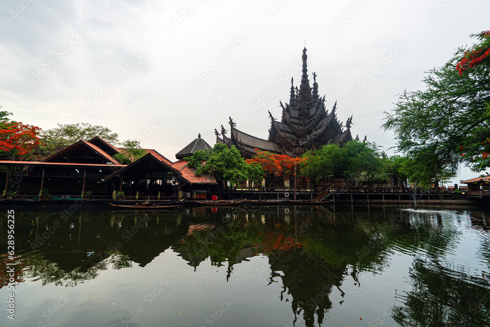 Sanctuary of Truth, Pattaya, Thailand, wooden temple by the ocean during sunset on beach of Pattaya. Temple of Truth in Thailand