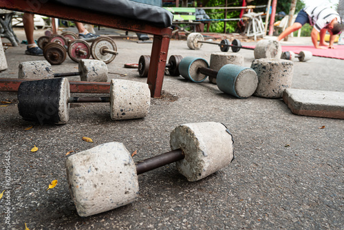 Close of rustic home made barbells and dumbbells