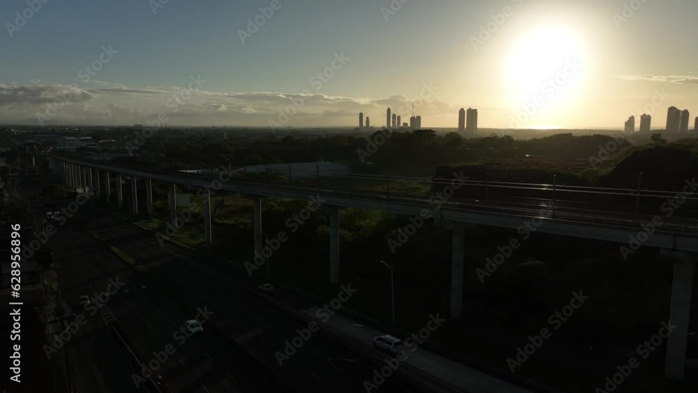 Aerial video of a road and a bridge surrounded by the city and a green field Aerial video of a road and a bridge surrounded by the city and a green field