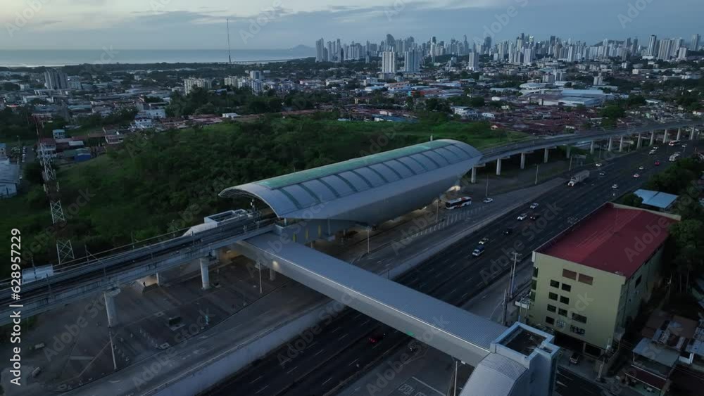 Aerial video of a roundabout and a bridge surrounded by the city and a green field