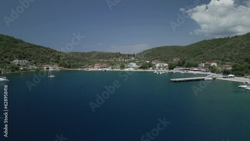 Aerial scene of Kalamitsi Beach with green mountains coastline and boats by the sea in Greece photo