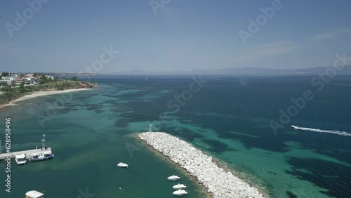 Drone footage over Nea Fokea port village with seascape on a sunny day photo