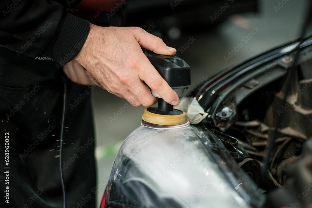 Person is professionally detailing a vehicle's trunk compartment using a polishing machine Person is professionally detailing a vehicle's trunk compartment using a polishing machine