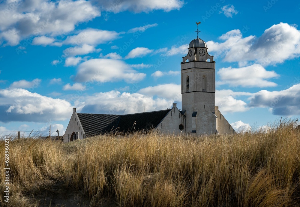 Fototapeta premium White church in Katwijk aan Zee, South Holland, seen from the beach