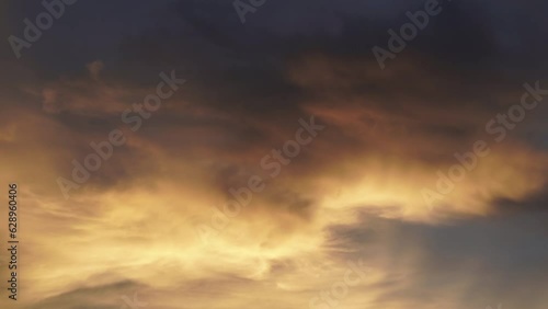 Cloud passing by with twilight sky and orange lighting on it. Warm feeling.