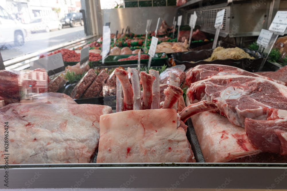 The butcher shop's refrigerated display showcases a variety of raw, fresh meats for customers to choose from. Ledbury DT Waller and Sons