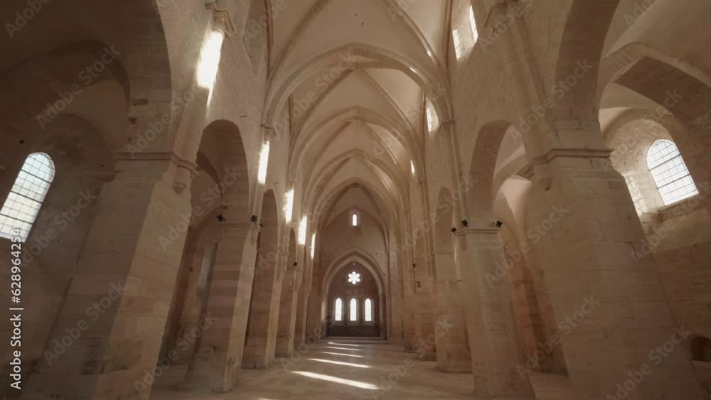 Beautiful view of the Abbaye de Noirlac corridor with columns Beautiful view of the Abbaye de Noirlac corridor with columns