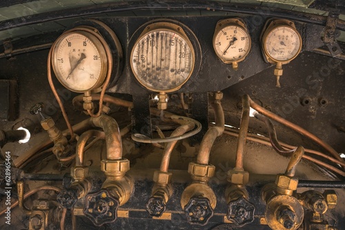 Pressure gauge and Feed water pump valves of an old japanese steam engine. photo