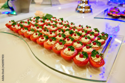 European buffet catering food. Tomato halves with cream cheese. Celebration party concept. Selective focus.