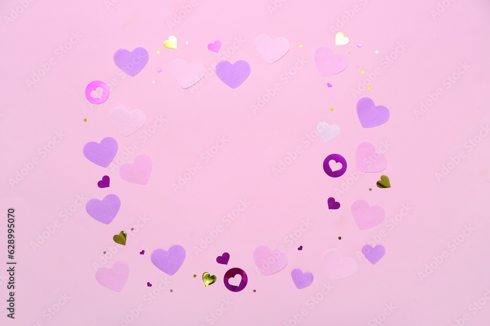 Frame made of hearts on pink background