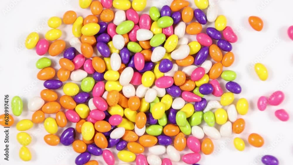 Multicolored candy coated fennel seed snack spinning clockwise - shallow depth of field. Multicolored candy coated fennel seed snack spinning clockwise - shallow depth of field.