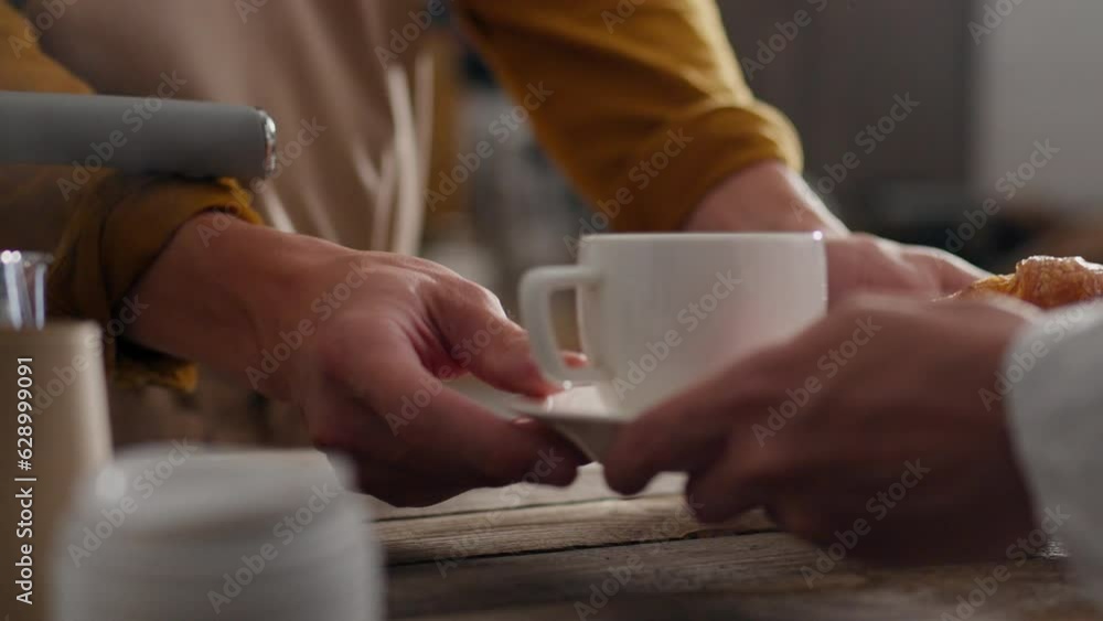 Bar, professional barista serves coffee order to customer in coffee bar the bartender in the process of preparing at the workplace follows the modern principles of morning drinks, receiving the parcel Bar, professional barista serves coffee order to customer in coffee bar the bartender in the process of preparing at the workplace follows the modern principles of morning drinks, receiving the parcel