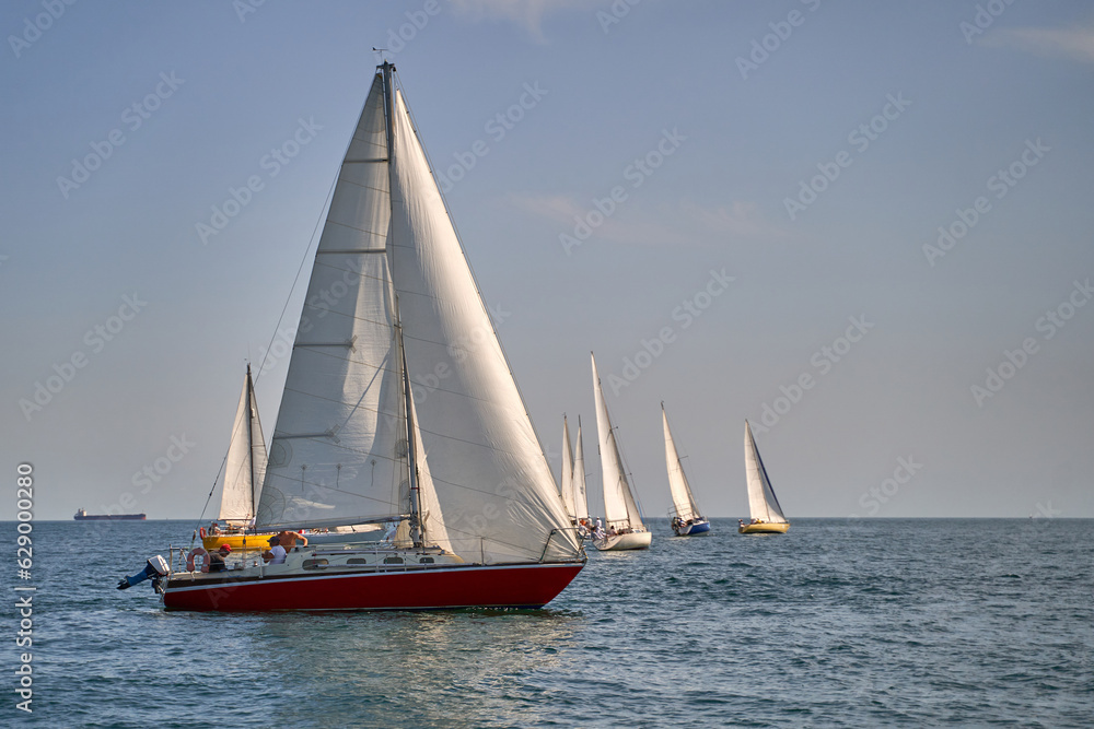 Sailing yacht regatta. Many sailing yachts in a row. sailing yachts under gennaker, speaker, genoa