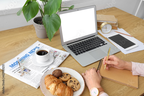 Woman working at table with...