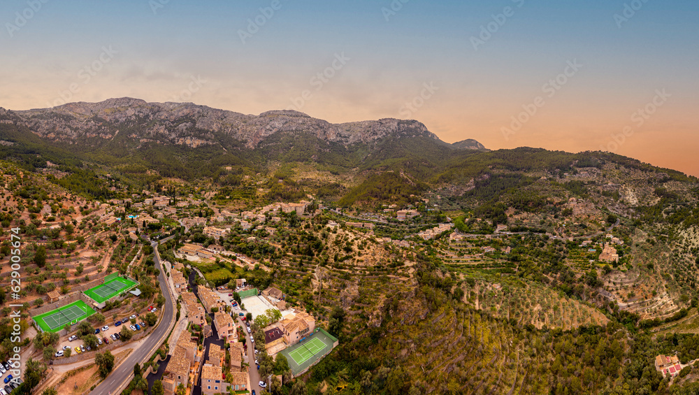 Aerial view of the mountain town Déia, Sunset on the Island of Mallorca in Spain, in the style of high dynamic range, Beautiful Mountain skyline in Serra de Tramuntana, travel vibes, summer time