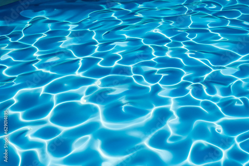 Vibrant blue water surface with captivating sunlit reflections  closeup view of a swimming pool