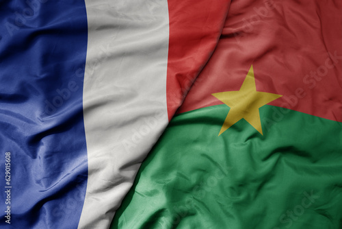 big waving realistic national colorful flag of france and national flag of burkina faso .