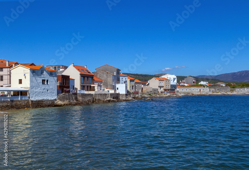 Fototapeta Naklejka Na Ścianę i Meble -  Houses on the sea in the town of Corrubedo. A Coruña, Galicia, Spain.