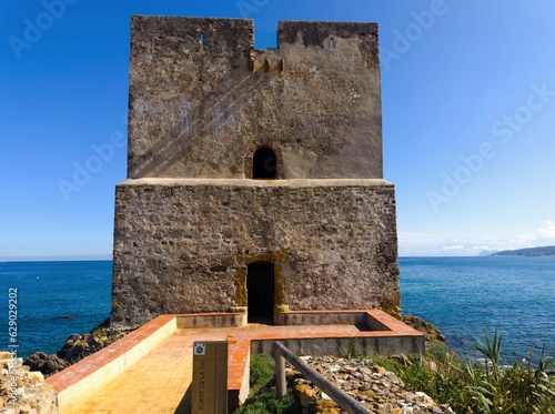 view of the Torre del Salto de la Mora tower, ruins, with the blue Mediterranean sea on the Andalusian coast, Bahía de Casares, Estepona, Andalusia, Malaga, Spain photo