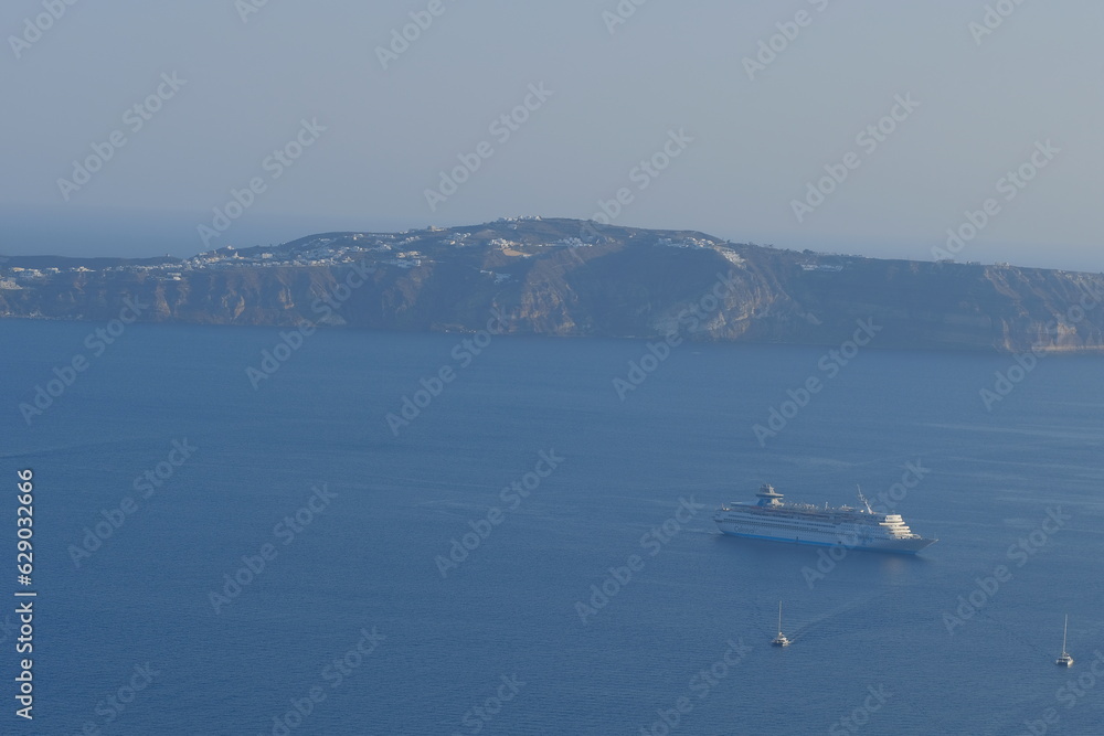 Boat sailing in the quiet shore landscape of Santorini, Greek Island