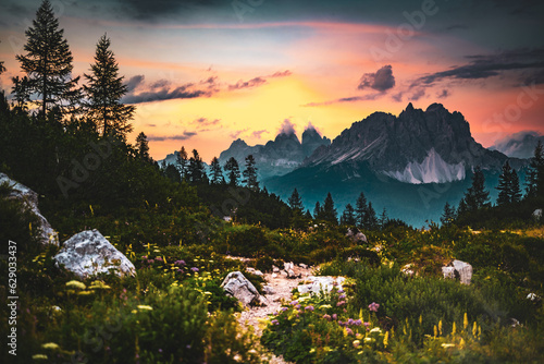 Hiking trail at Sorapis lake with mystic view on Cadini di Misurina in the background in the evening. Lake Sorapis, Dolomites, Belluno, Italy, Europe.
