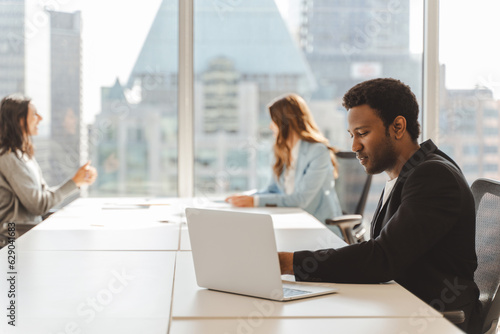 Portrait of pensive serious African American man wearing formal clothes, taking notes in modern office. Successful businessman planning project, attractive student preparing for exam