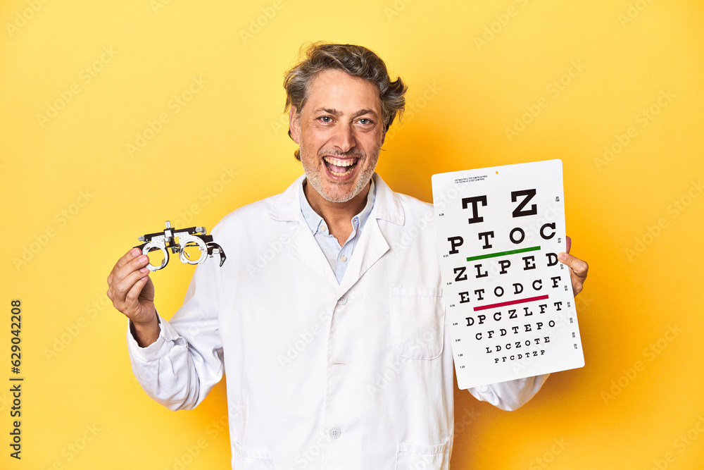 Optometrist with special glasses and visual acuity test on a yellow backdrop. Optometrist with special glasses and visual acuity test on a yellow backdrop.