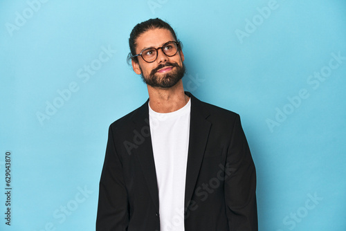 Businessman in suit with eyeglasses and beard dreaming of achieving goals and purposes © Asier