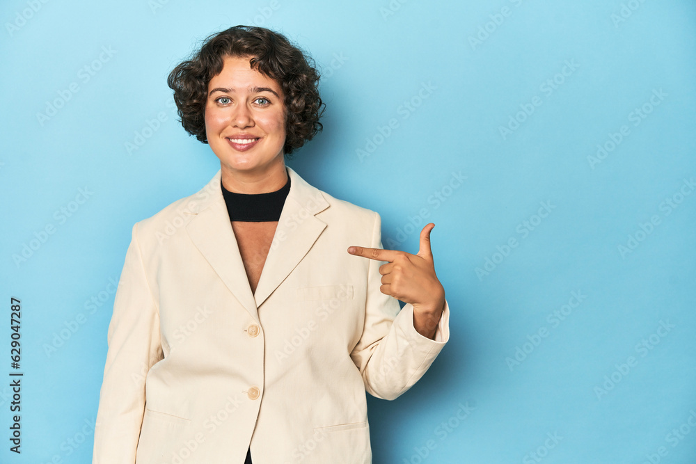 Young woman in elegant white blazer person pointing by hand to a shirt copy space, proud and confident Young woman in elegant white blazer person pointing by hand to a shirt copy space, proud and confident