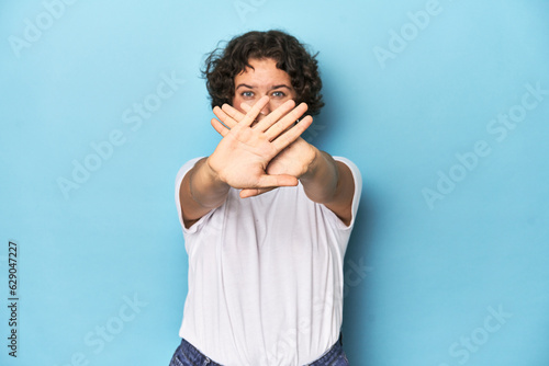 Young Caucasian woman with short hair doing a denial gesture